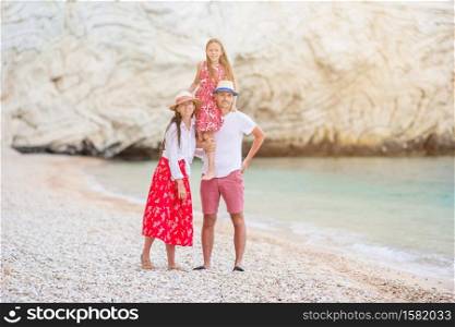 Portrait of family of three on the bech vacation. Beautiful tropical beach landscape with family enjoying summer vacation