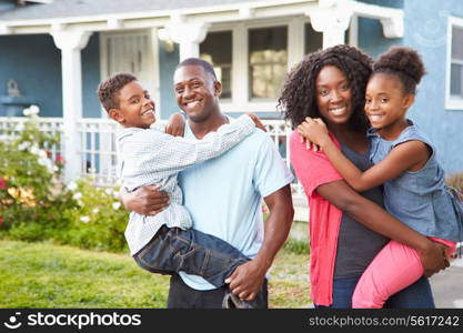 Portrait Of Family Outside Suburban Home