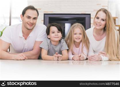 Portrait of family. Portrait of four people family with children at home over chimney background