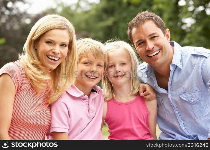 Portrait Of Family Relaxing In Countryside