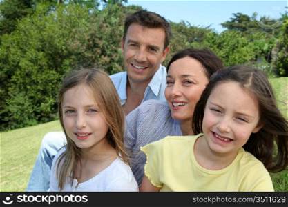 Portrait of family sitting in park