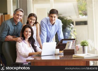 Portrait Of Family Using Laptop Together
