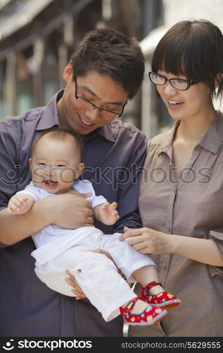 Portrait of family with baby, holding baby