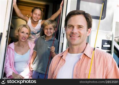 Portrait of family with camper van