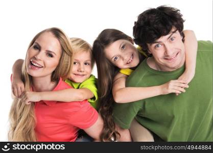 Portrait of family with children. Studio portrait of family in colorful clothes with two children isolated on white background