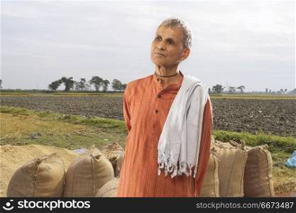 Portrait of farmer standing in paddy field