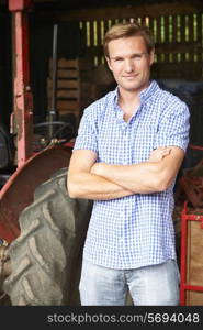 Portrait Of Farmer With Old Fashioned Tractor