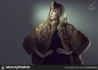 portrait of fashion blonde girl posing with creative blonde hair-style and elegant warm fur coat. Winter style