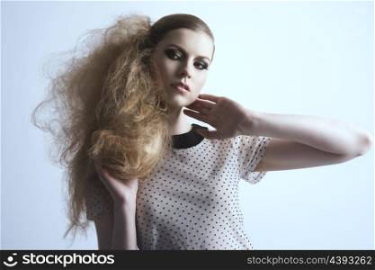 portrait of fashion blonde girl with strong make-up and creative modern hair-style