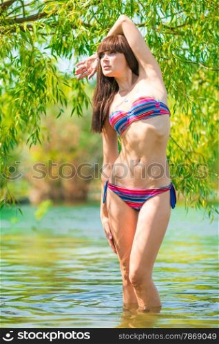 portrait of fashion model in a lake in the shade of trees