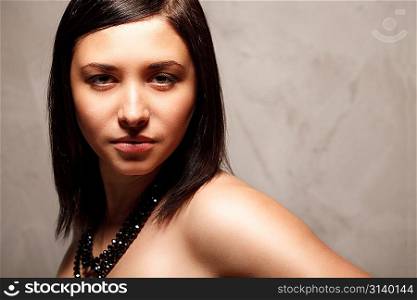 Portrait of fashionable woman over stone background