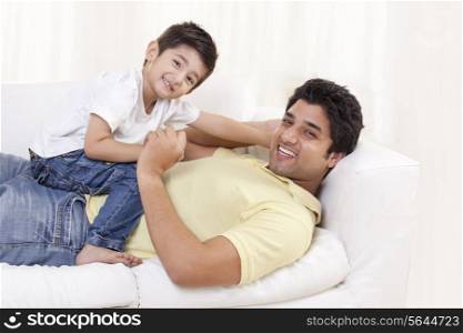Portrait of father and child on sofa