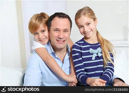 Portrait of father and children at home