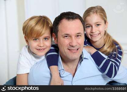 Portrait of father and children at home