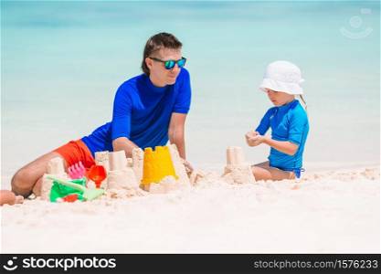 Portrait of father and daughter background of the sea. Little girl and happy dad having fun during beach vacation