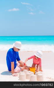 Portrait of father and daughter background of the sea. Little girl and happy dad having fun during beach vacation