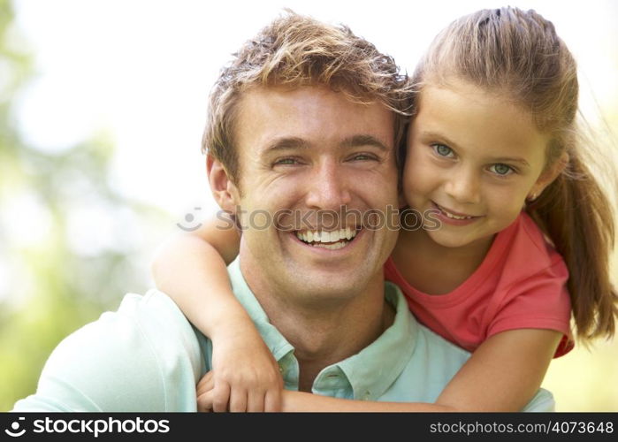 Portrait Of Father And Daughter In Park