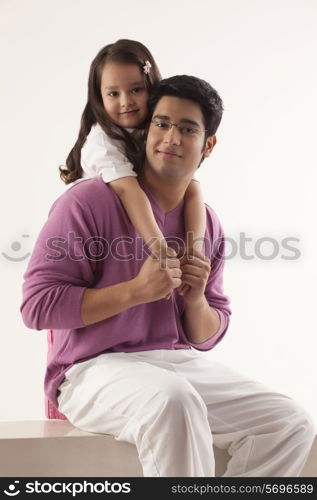 Portrait of father and daughter over white background