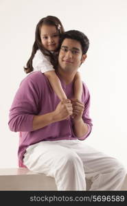 Portrait of father and daughter over white background