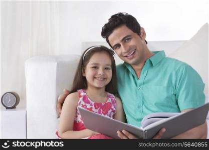 Portrait of father and daughter with file at home