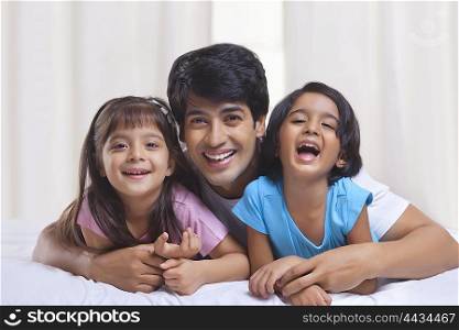 Portrait of father and kids smiling