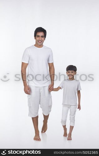 Portrait of father and son holding hands