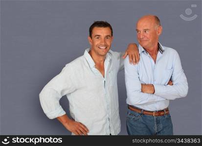 Portrait of father and son on grey background