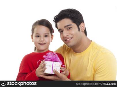 Portrait of father giving gift to his daughter