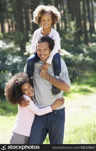 Portrait Of Father With Daughters In Countryside