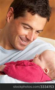 Portrait Of Father With Newborn Baby At Home
