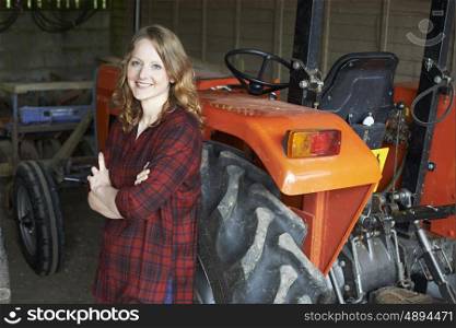 Portrait Of Female Agricultural Worker With Tractor