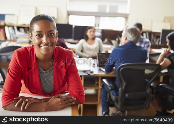 Portrait Of Female Architect With Meeting In Background