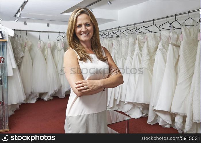 Portrait Of Female Bridal Store Owner With Wedding Dresses