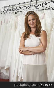 Portrait Of Female Bridal Store Owner With Wedding Dresses