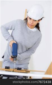 portrait of female carpentry using power drill
