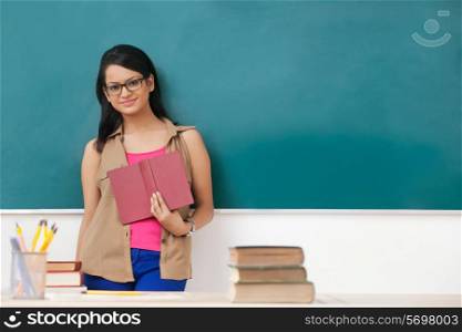Portrait of female college student with a book