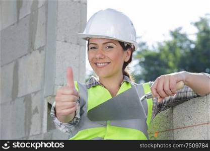 portrait of female constructor showing like gesture