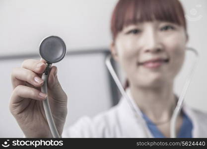 Portrait of female doctor holding a stethoscope, Close-Up