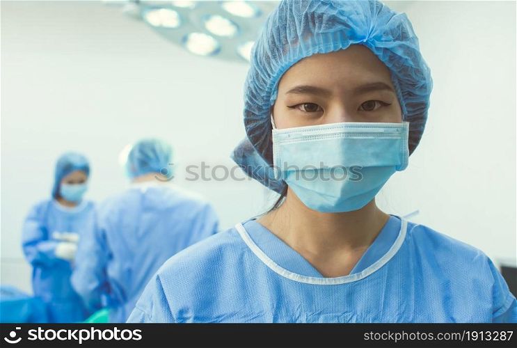 Portrait of female doctor wearing mask and standing in hospital for medical operation