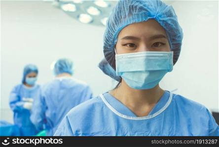 Portrait of female doctor wearing mask and standing in hospital for medical operation