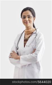 Portrait of female doctor with stethoscope around neck isolated over white background