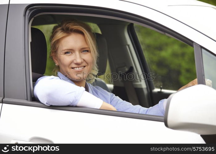 Portrait Of Female Driver Looking Out Of Car Window