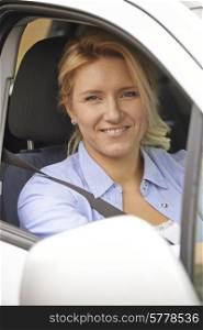 Portrait Of Female Driver Looking Out Of Car Window