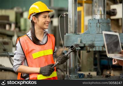 Portrait of female Engineer standing with confident against machine environment in factory