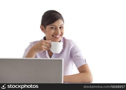 Portrait of female executive having coffee