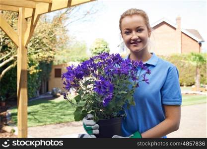 Portrait Of Female Landscape Gardener Holding Plant