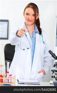 Portrait of female medical doctor at office pointing finger in camera&#xA;