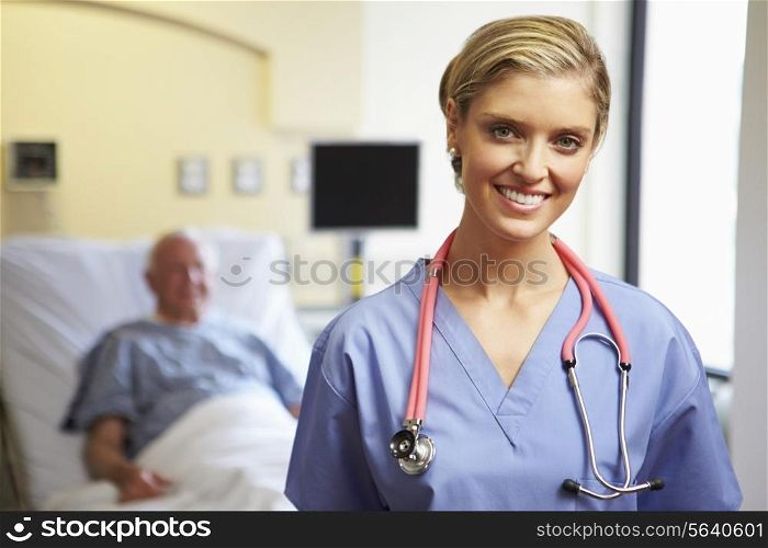Portrait Of Female Nurse With Patient In Background