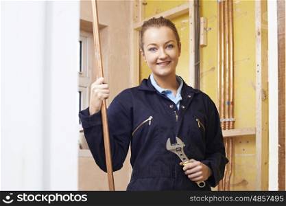 Portrait Of Female Plumber Working In House