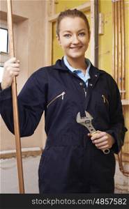 Portrait Of Female Plumber Working In House